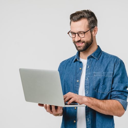 Successful caucasian young man student freelancer using laptop, watching webinars, working remotely, e-learning e-commerce online isolated in white background